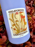 Blue bottle with a label featuring carnivorous plants and 'California Carnivores' branding.