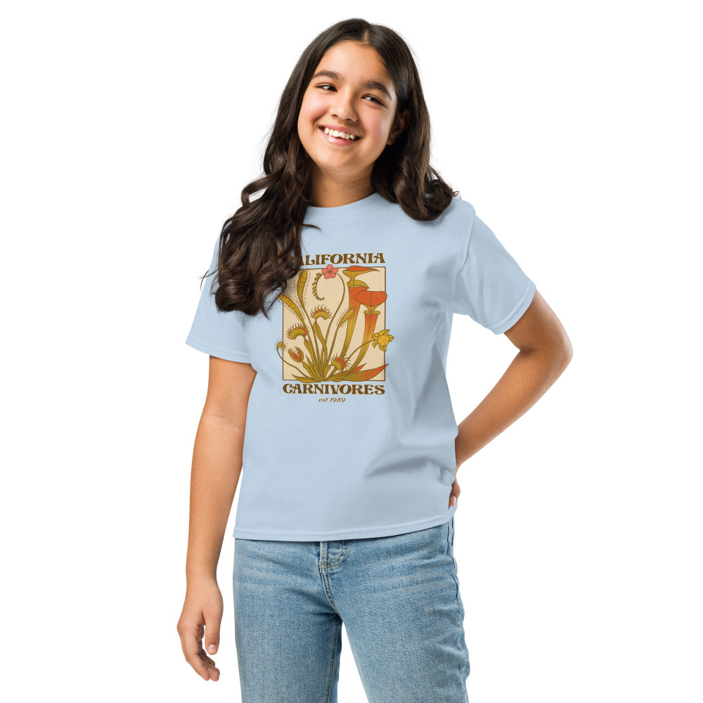 Girl wearing a light blue t-shirt with a graphic design on a white background