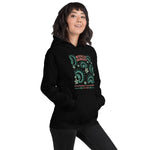 Black California Carnivores unisex hoodie with Wicked Hungry in coral, in the upper middle, surrounded by wood block print style flytraps in teal on female model