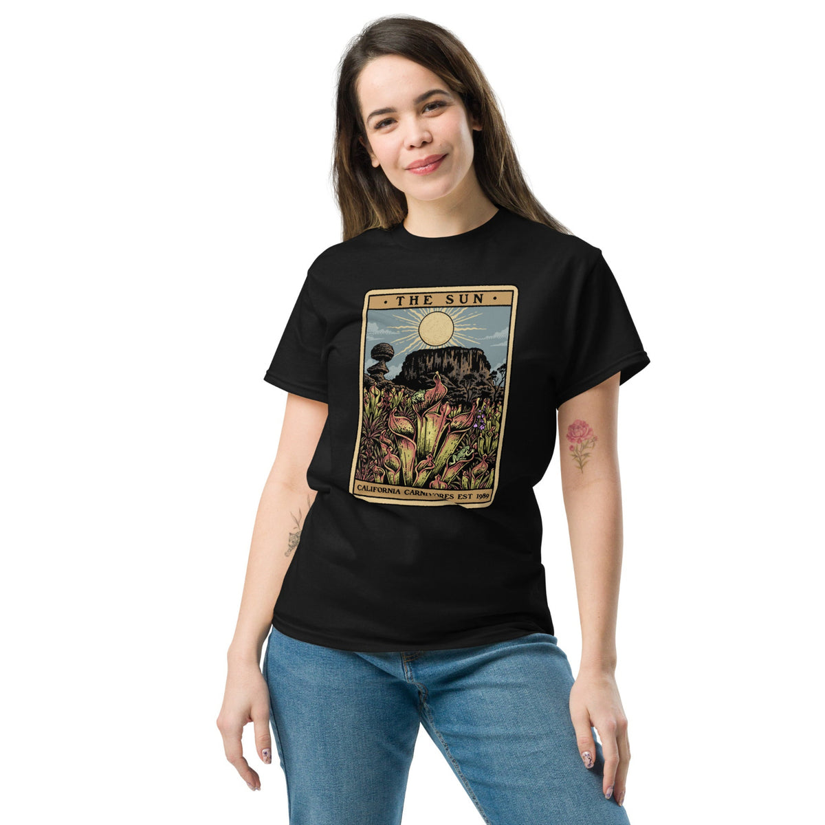 Black t-shirt with a graphic design of Heliamphora as the Sun tarot card on female model