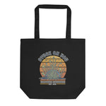 Black tote bag with a graphic design and text on a white background