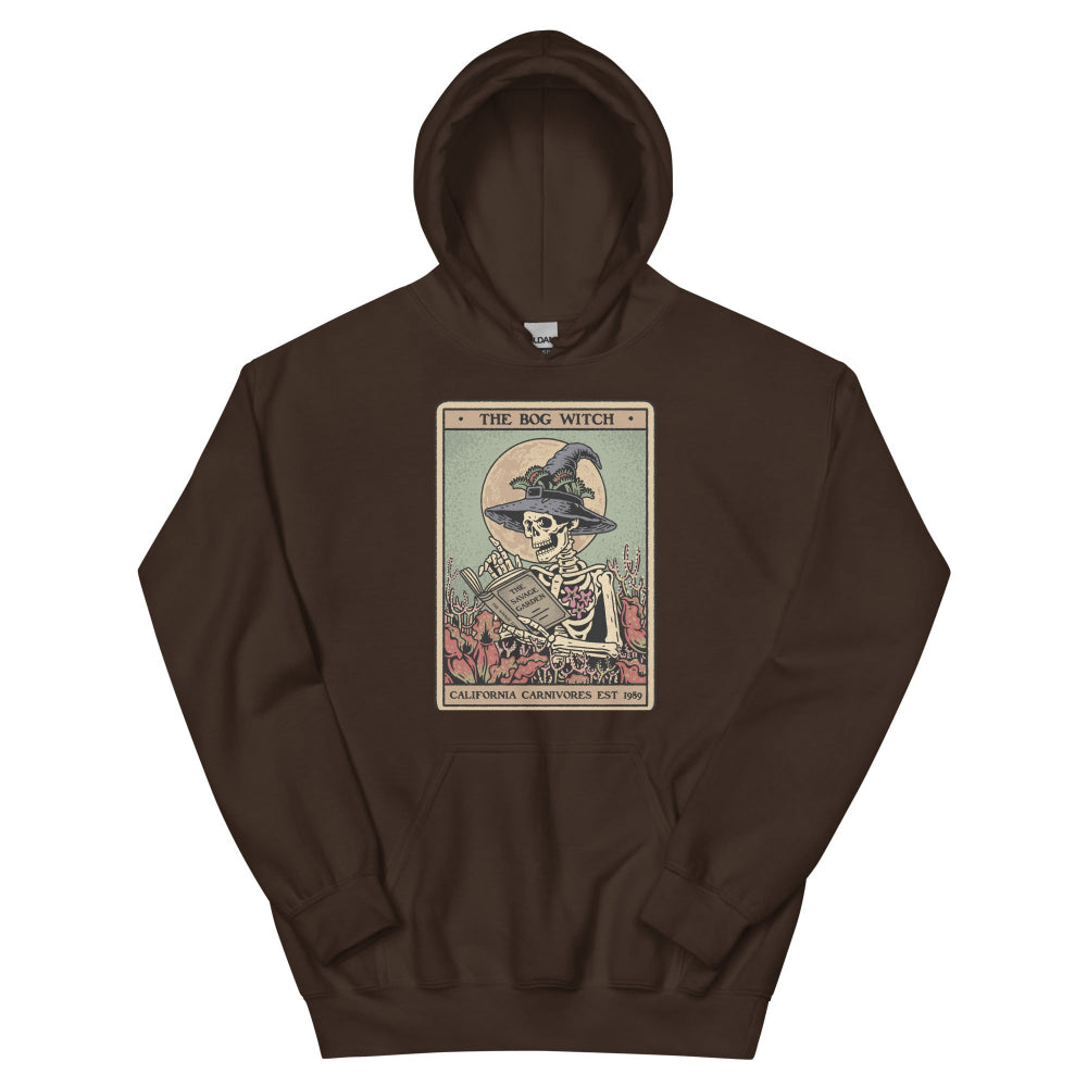 Brown hoodie with a graphic of a skeleton in a witch hat and broomstick on a white background