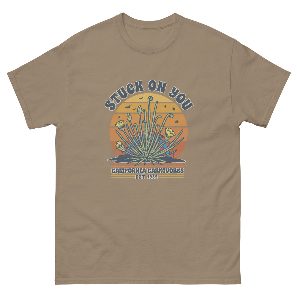 Brown t-shirt with a graphic design featuring cacti and text on a white background