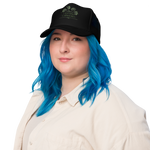 Person with blue hair wearing a black cap on a white background