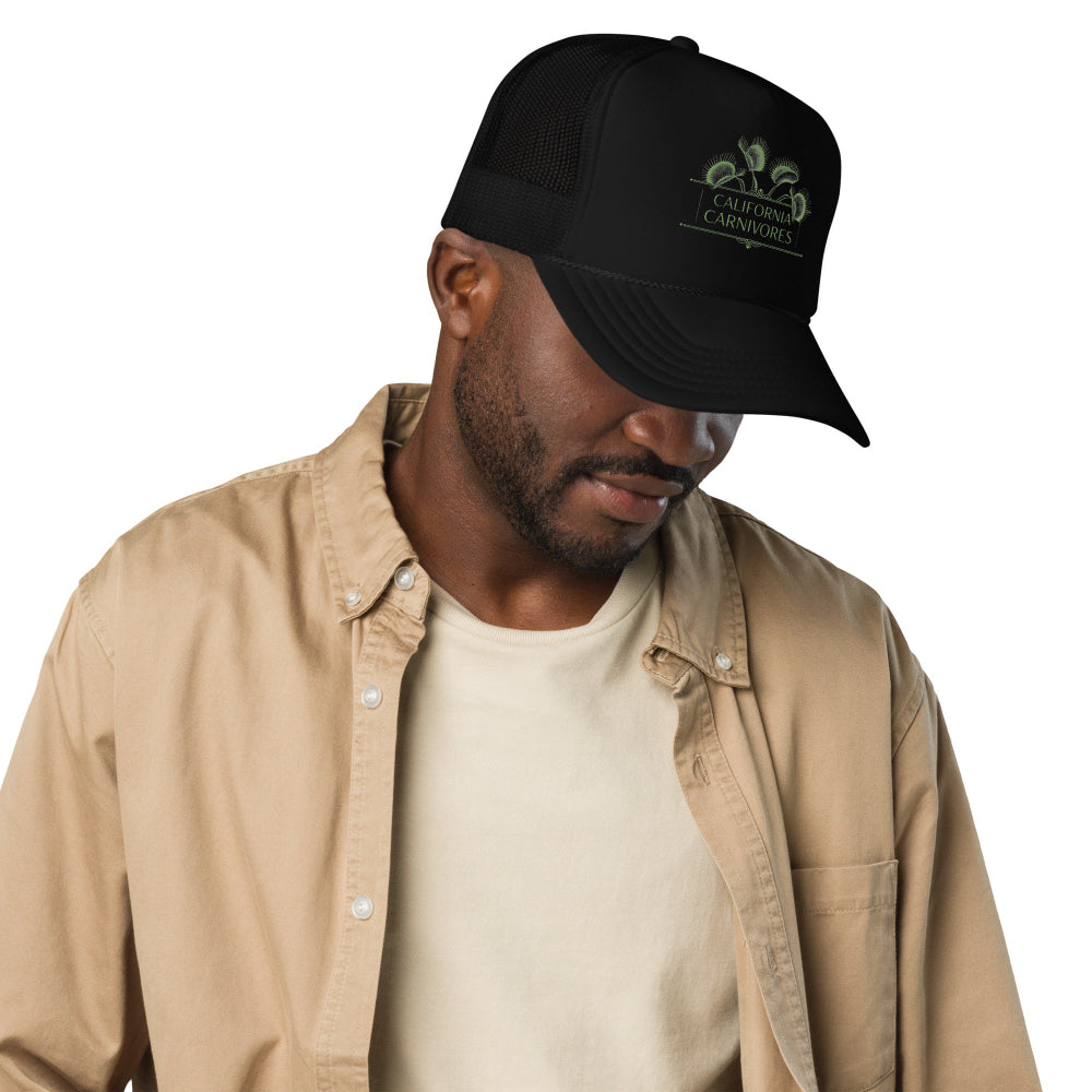 Man wearing a black cap with a logo on a white background