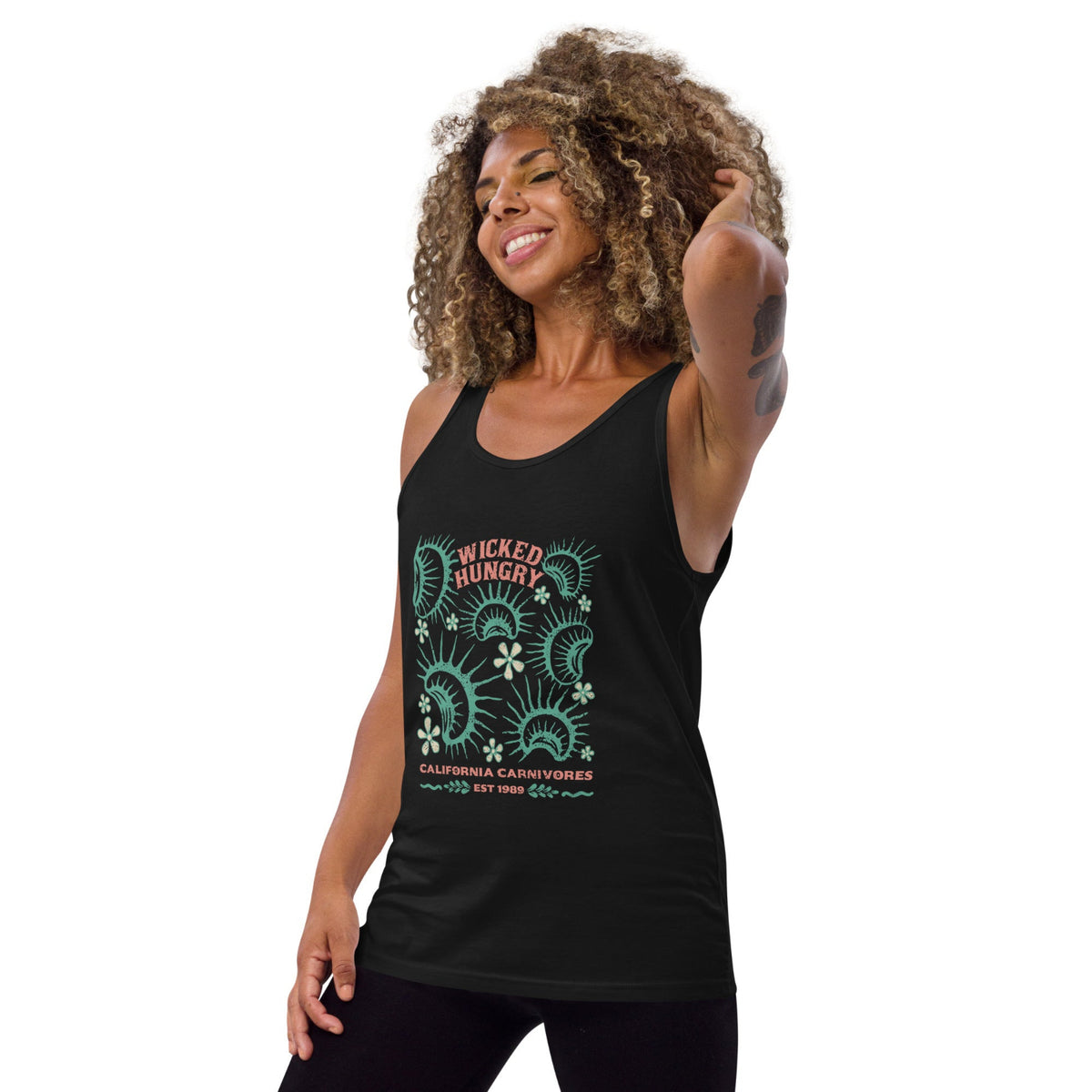 California Carnivores unisex tank top with Wicked Hungry in coral, in the upper middle, surrounded by wood block print style flytraps in teal on female model