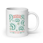 California Carnivores mug with Wicked Hungry in coral, in the upper middle, surrounded by wood block print style flytraps in teal