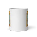 White mug with a gold and black design on a white background