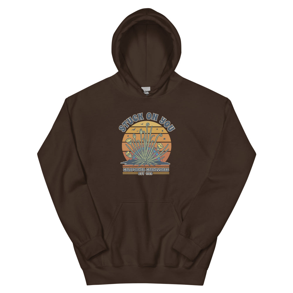 Dark chocolate hoodie with a graphic of a face and text on a white background