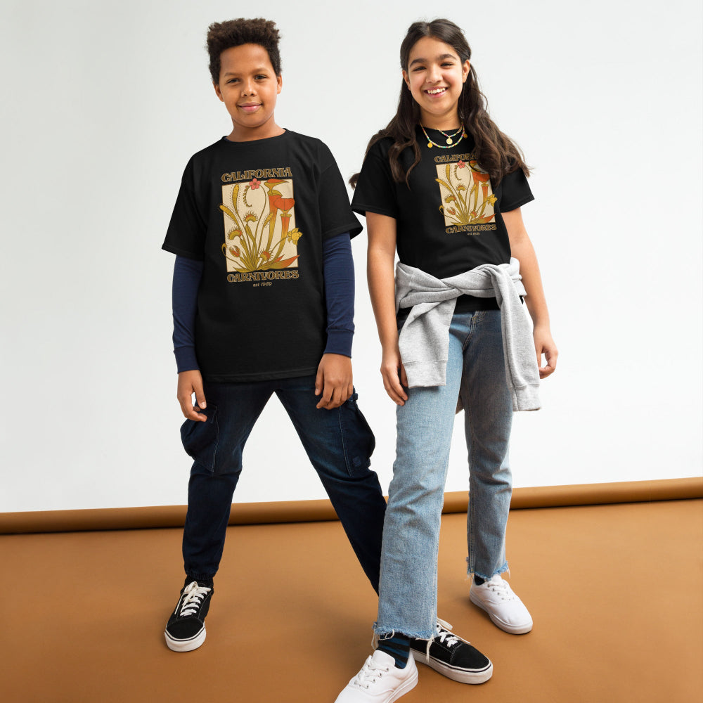 Two children wearing black t-shirts with graphic designs on a white background