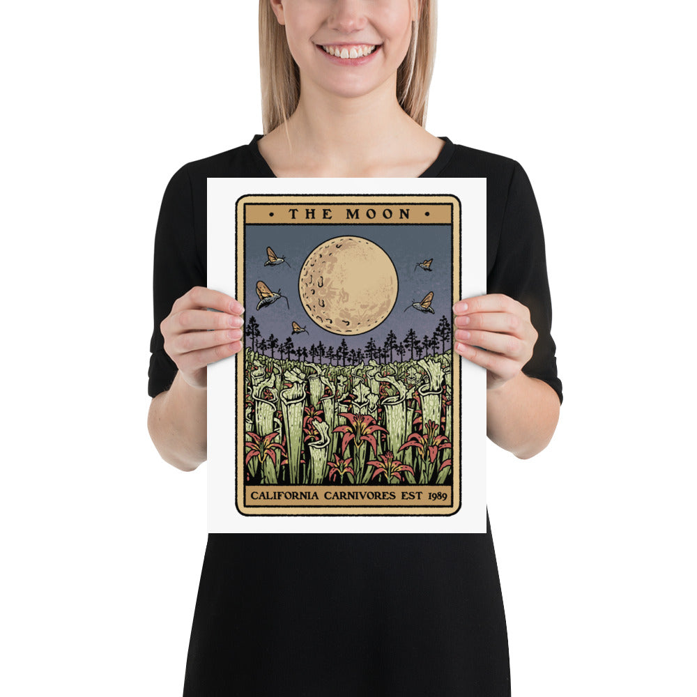Person holding a print of the tarot card themed design with a moon and plants