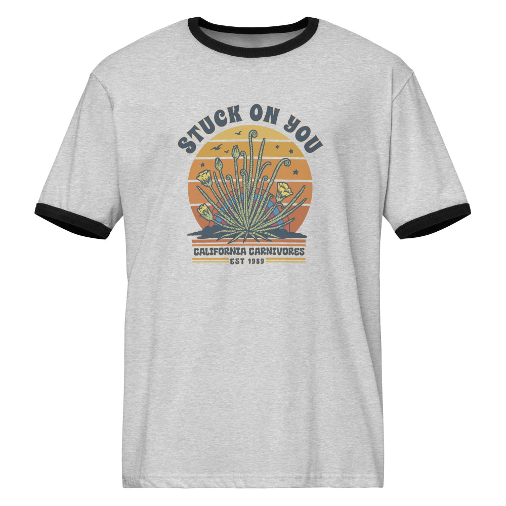 Gray t-shirt with black trim featuring a graphic design on a white background