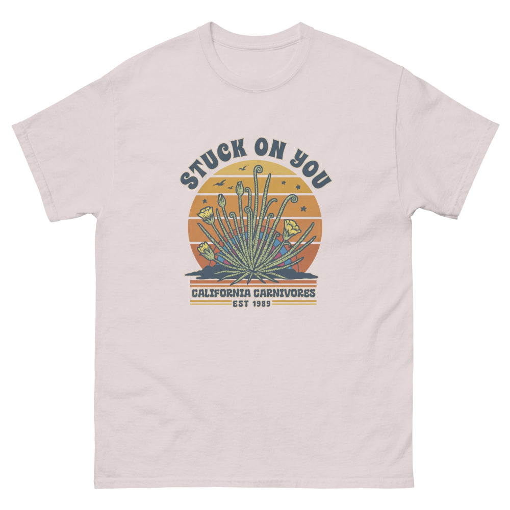 Ice grey t-shirt with a graphic design featuring text and plant-like elements on a white background