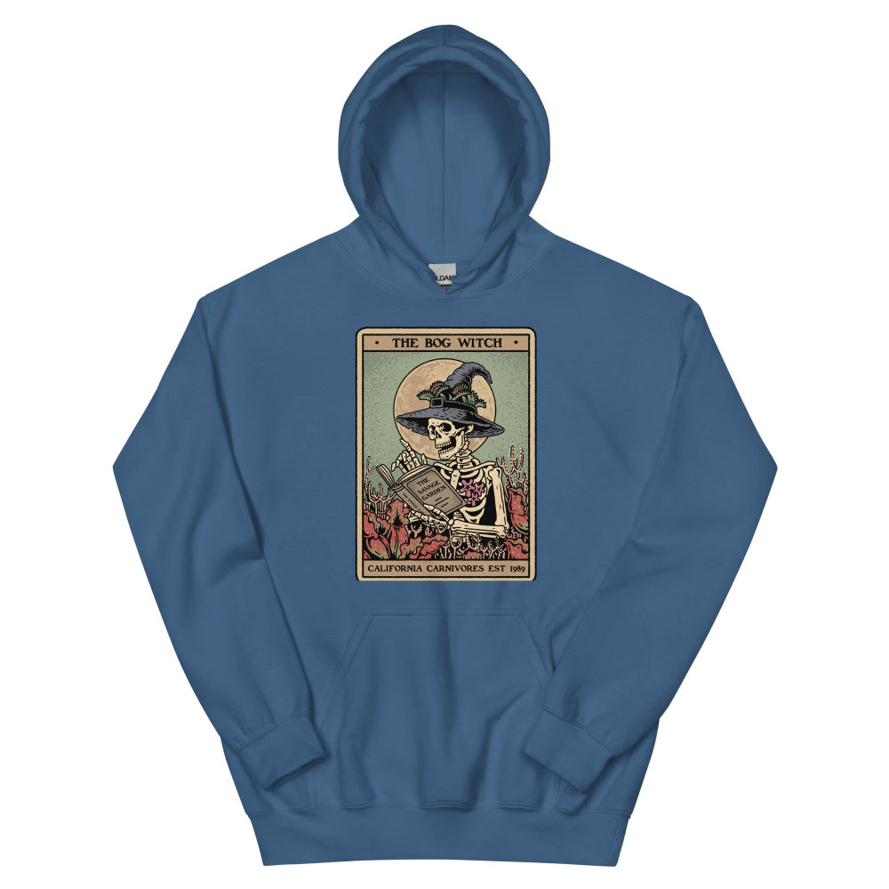 Blue hoodie with a graphic design of a skeleton wearing a witch hat and holding a broomstick on a white background.