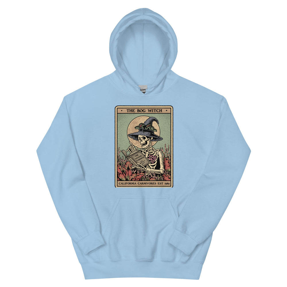 Light blue hoodie with a graphic of a skeleton in a witch hat and a book on a white background