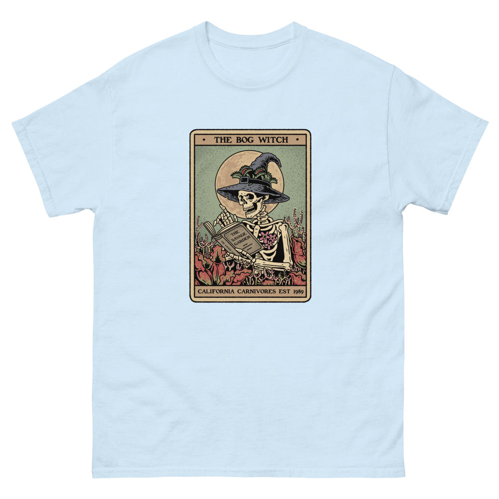 Light blue t-shirt with a graphic of 'The Bog Witch' design on a white background
