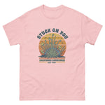Pink t-shirt with graphic design and text on a white background