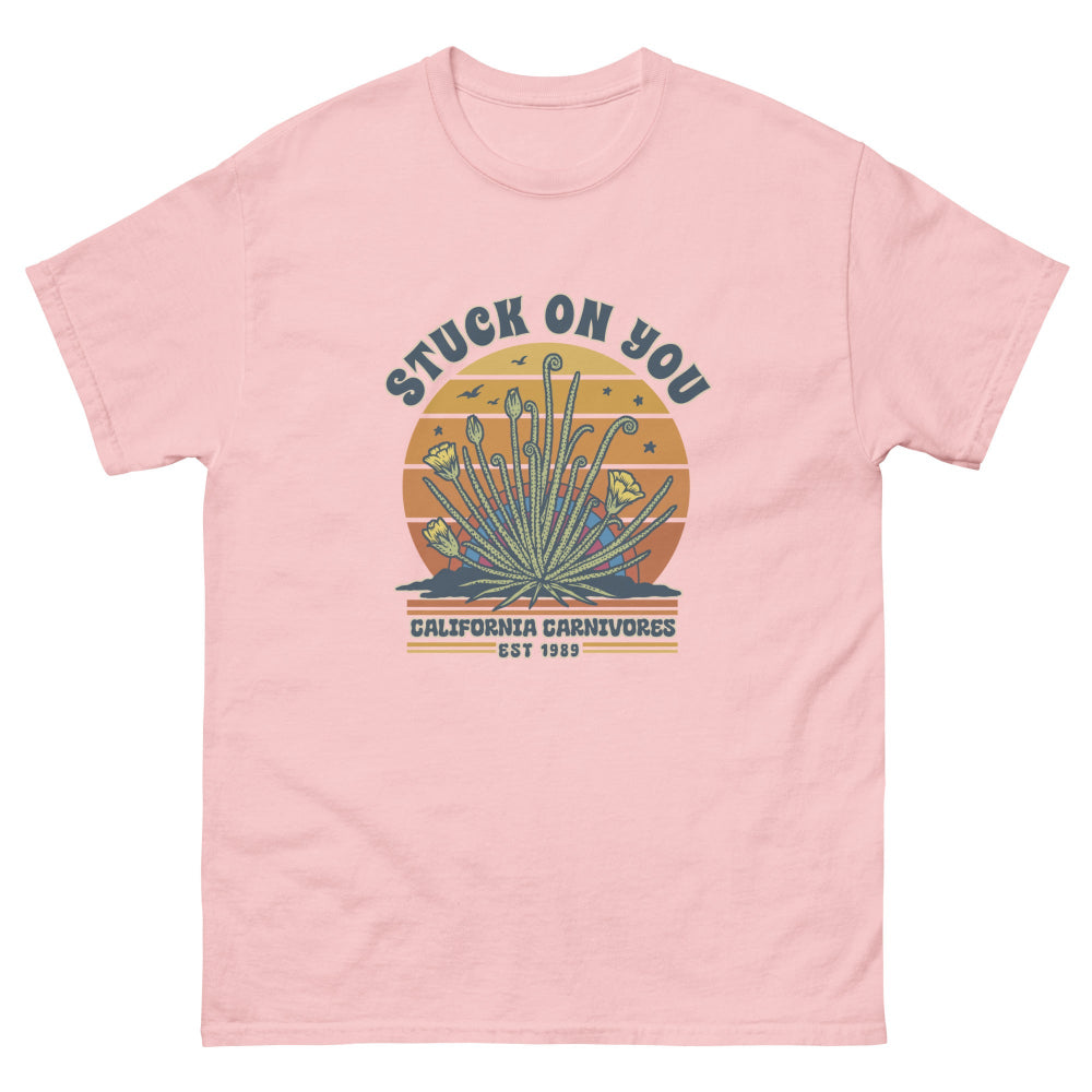Pink t-shirt with graphic design and text on a white background