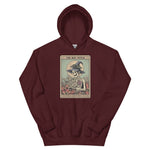 Maroon hoodie with a tarot card-style design featuring a skeleton in a witch hat on a white background.