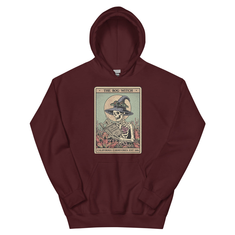 Maroon hoodie with a tarot card-style design featuring a skeleton in a witch hat on a white background.