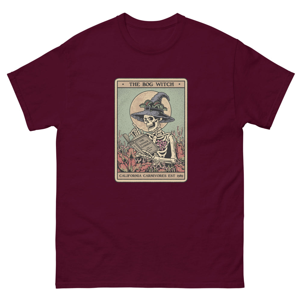 Maroon t-shirt with a graphic of a skeleton in a witch hat and broomstick, labeled 'The Bog Witch'.