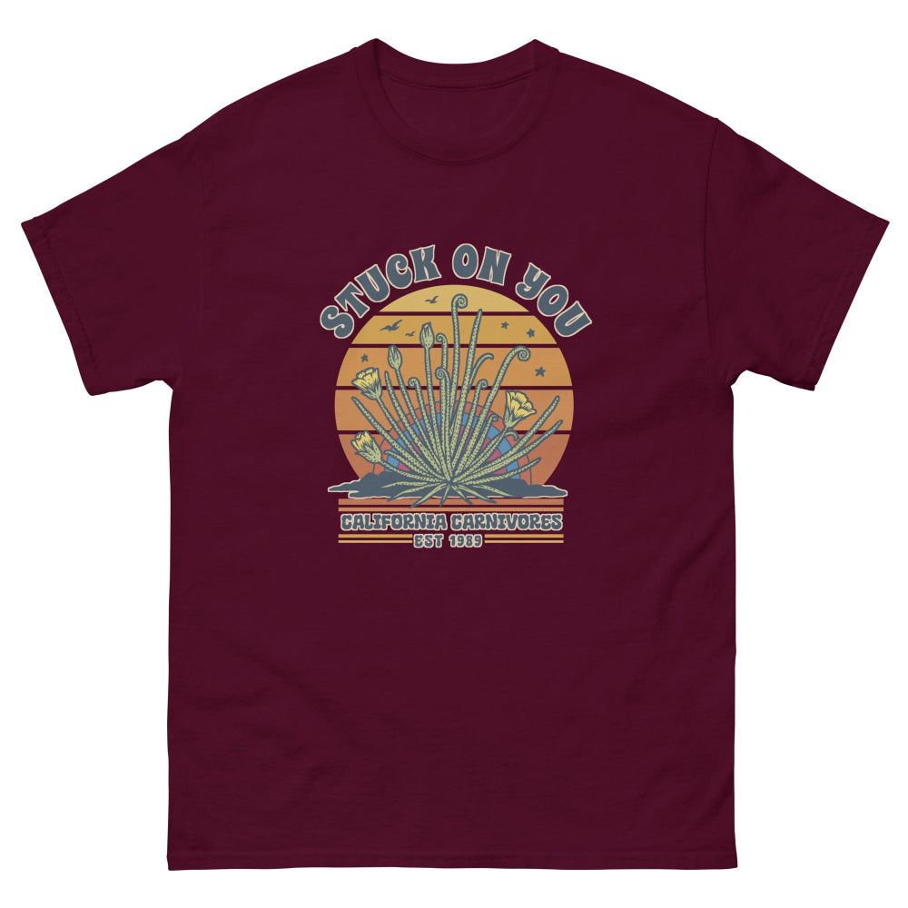 Maroon t-shirt with a graphic design and text on a white background
