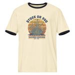 Beige t-shirt with graphic design and text on a white background