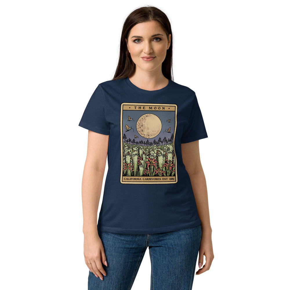 Woman wearing a navy blue t-shirt with a graphic design on a white background