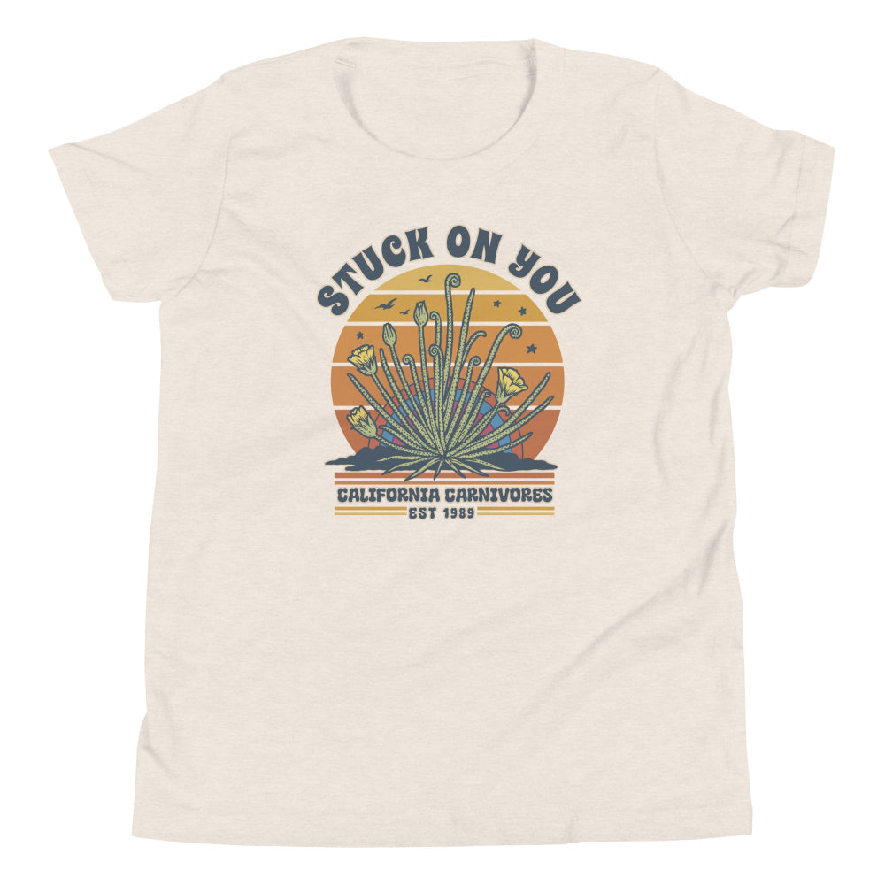 Sand colored t-shirt with graphic design and text on a white background