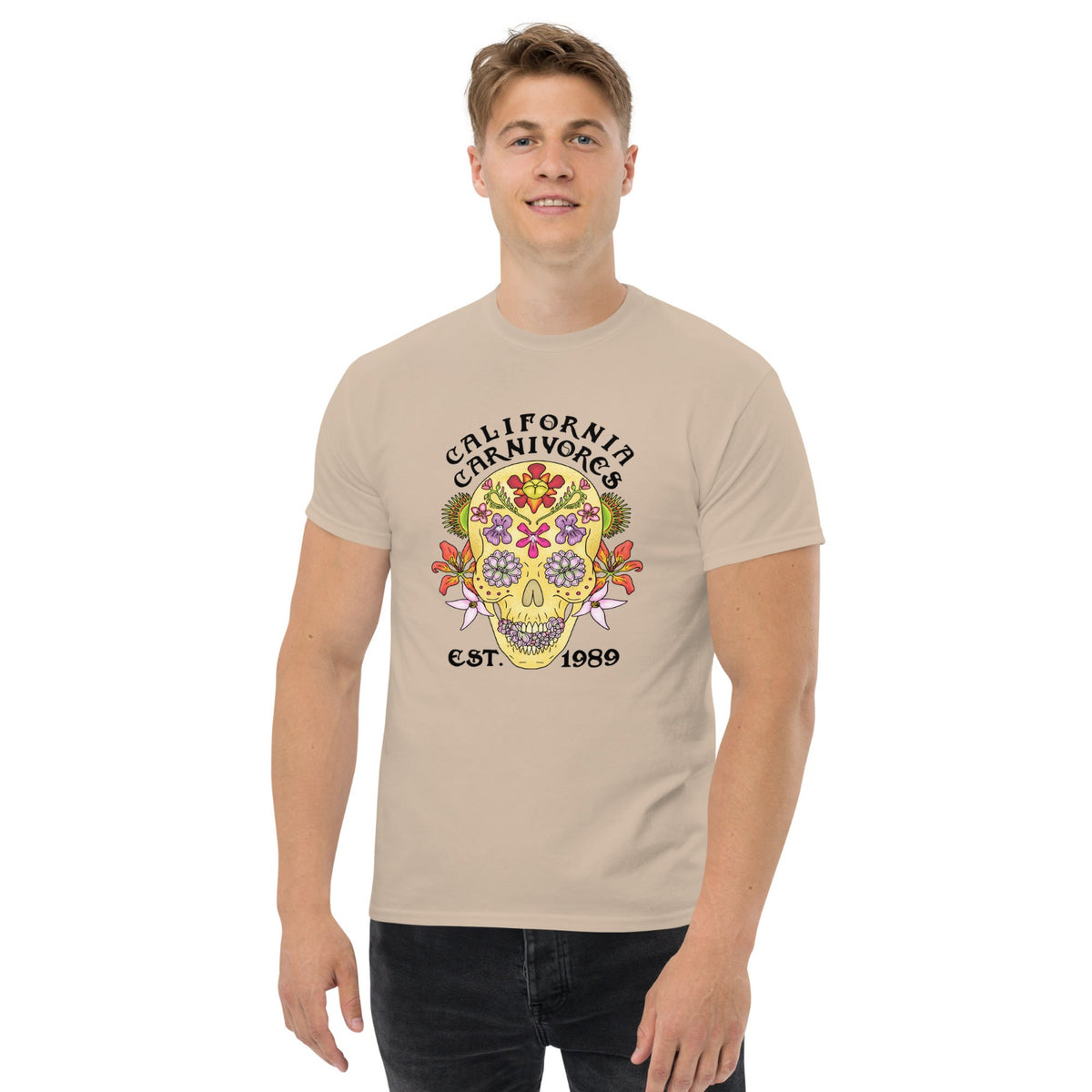 Person wearing a sand colored t-shirt with a colorful skull design and text on a white background