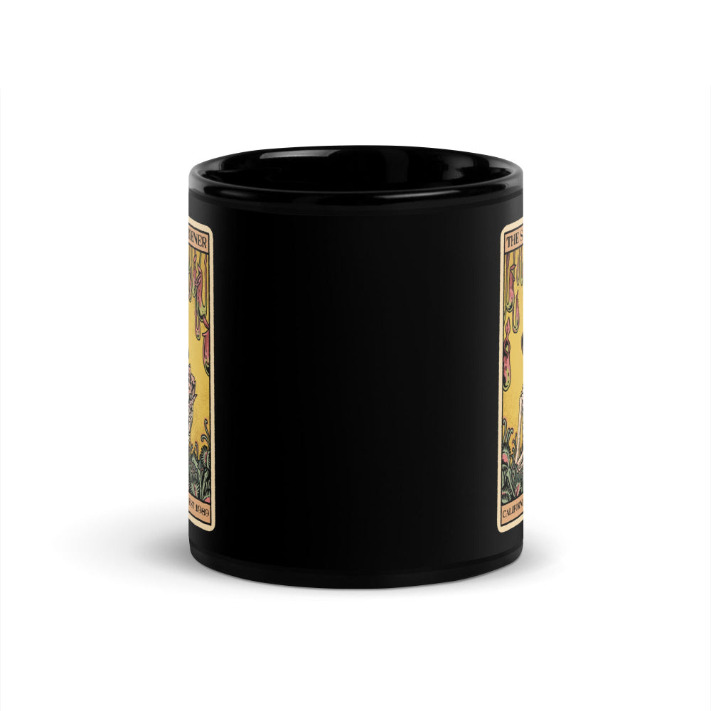 Black mug with tarot card designs on a white background