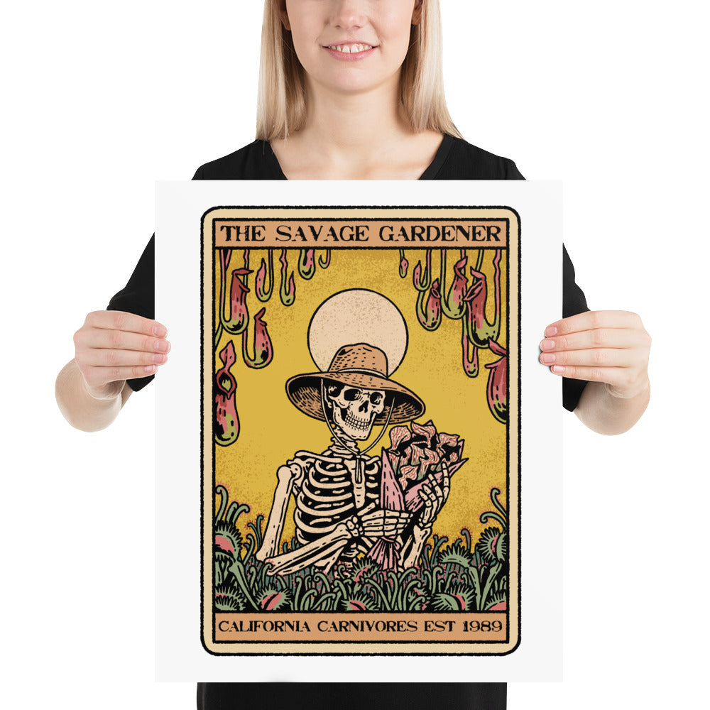 Person holding a poster with a skeleton wearing a hat and holding flowers, titled 'The Savage Gardener'.