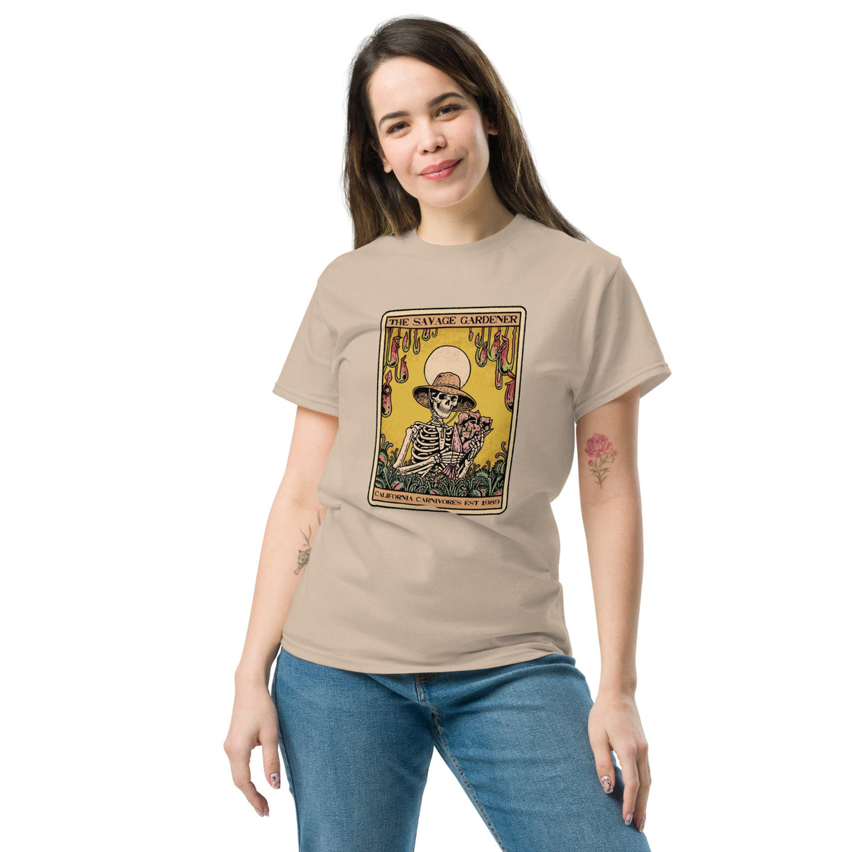 Woman wearing a beige t-shirt with a graphic design on a white background