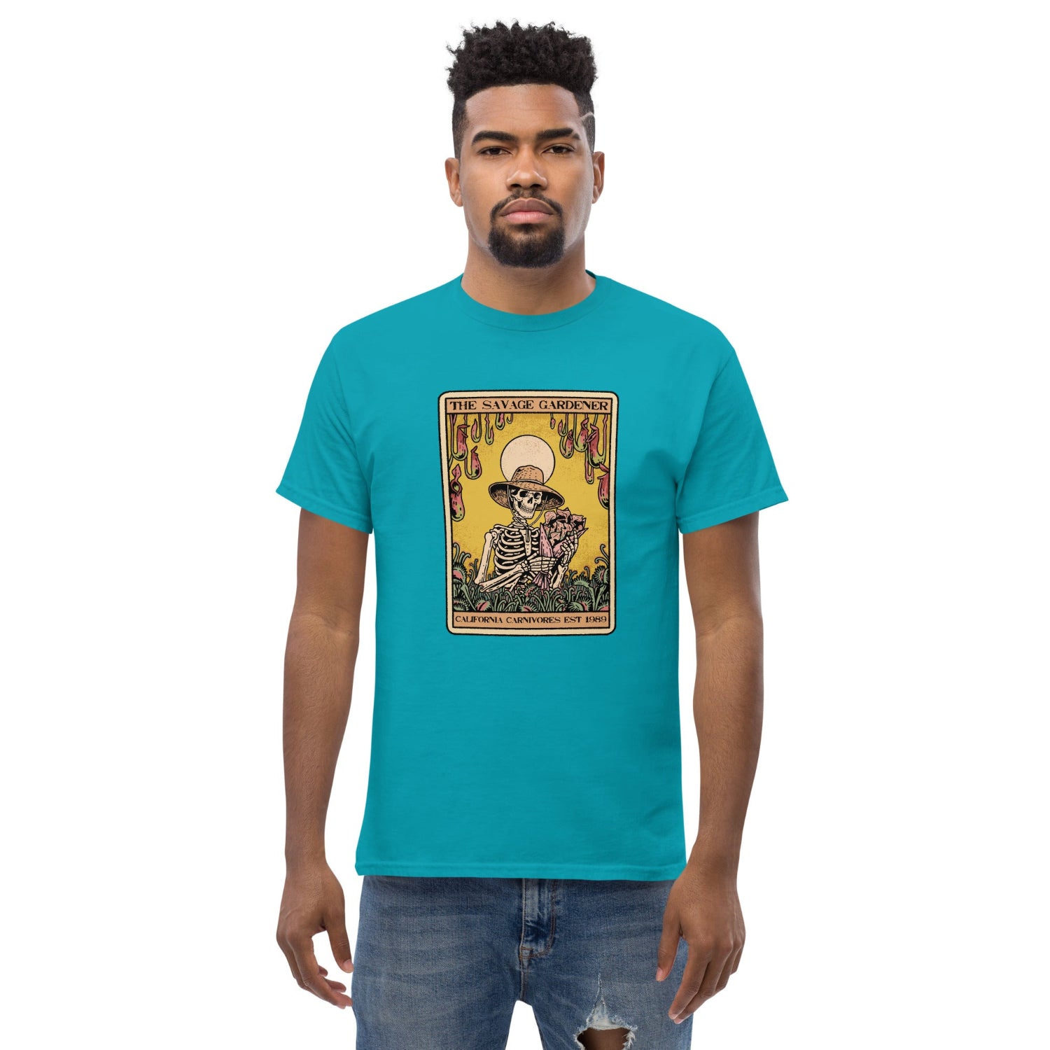 Man wearing a turquoise t-shirt with a graphic design on a white background