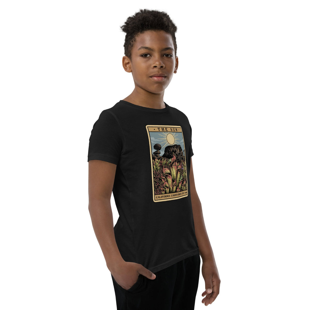 The Shining Sun youth unisex shirt has a heliamphora in the sun styled after a tarot card worn by a model