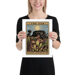 Person holding a framed artwork titled 'The Sun' by California Carnivores.