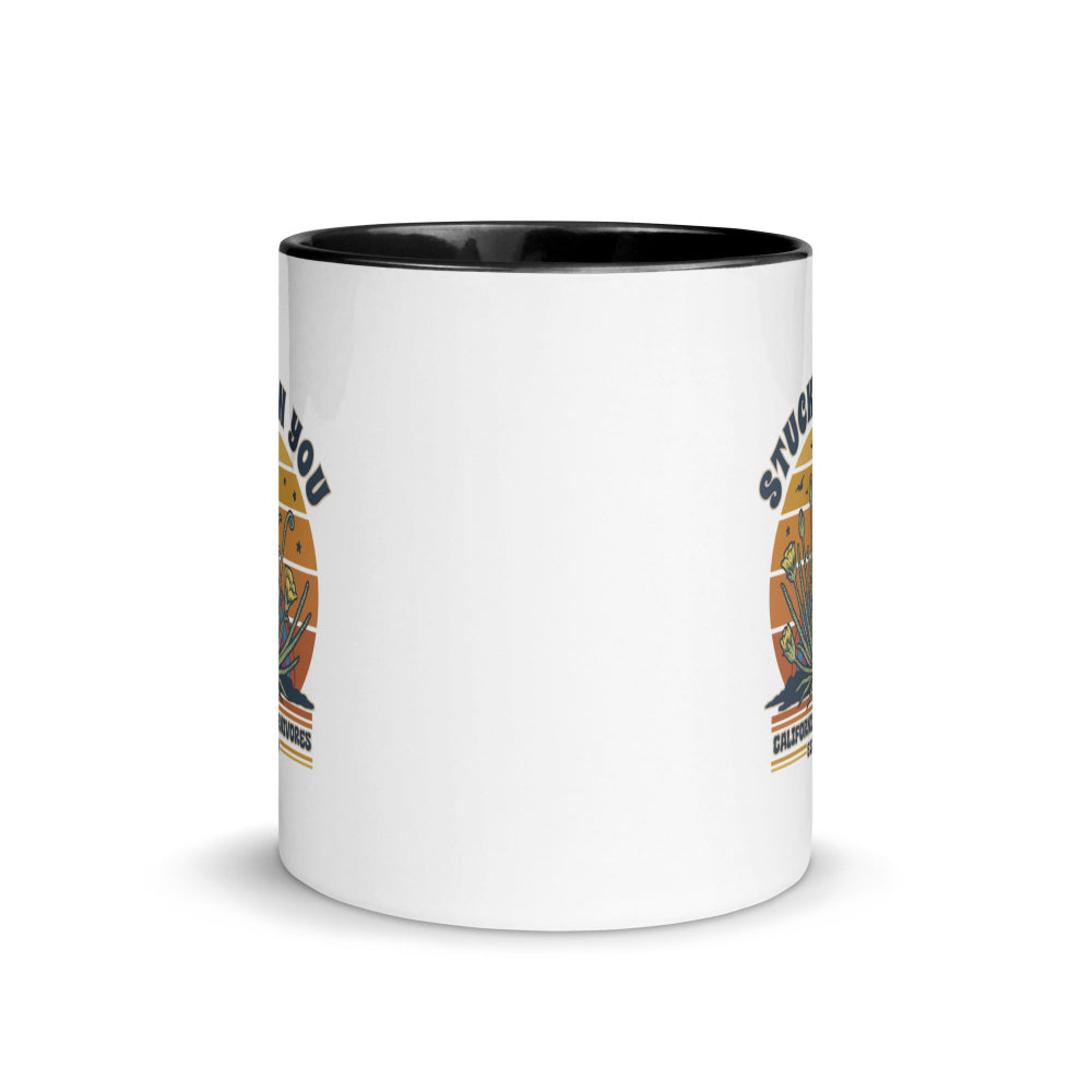 White mug with gold circular design and text on a white background