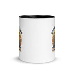 White mug with gold circular design and text on a white background