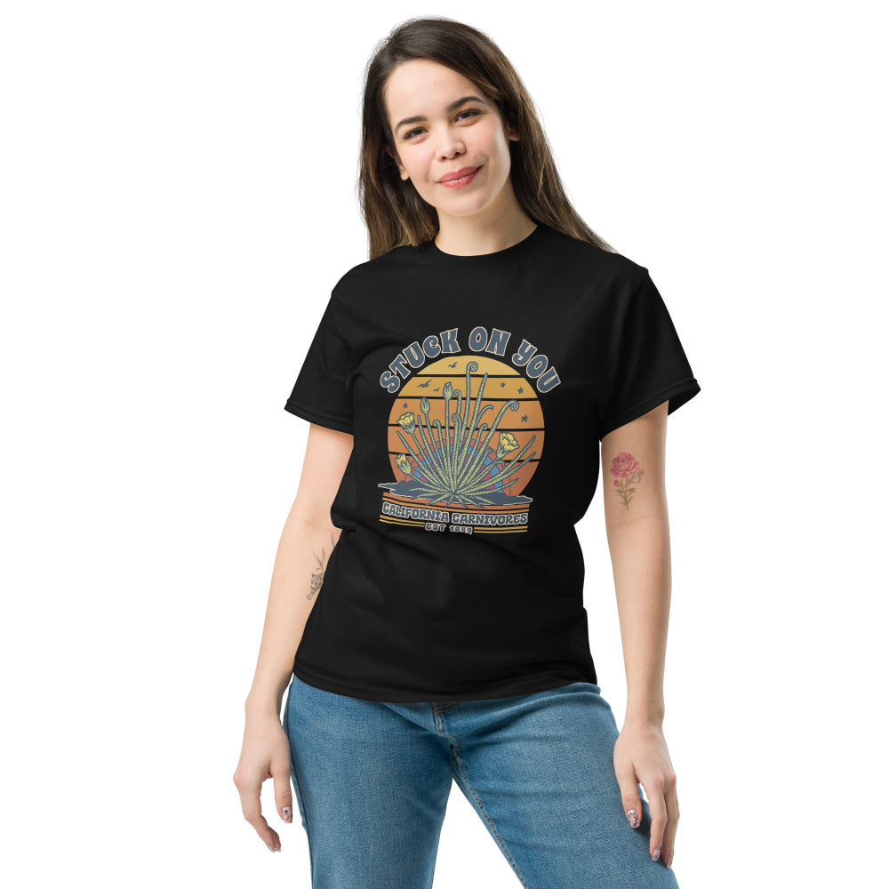 Woman wearing a black t-shirt with 'Stuck on You' design on a white background