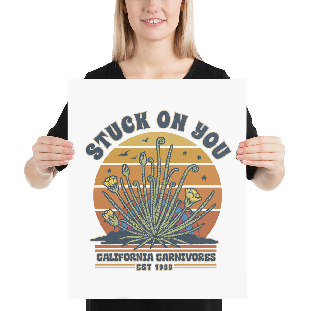 Person holding a poster with a desert plant design and text.