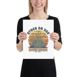 Person holding a poster with a graphic design of cacti and text.