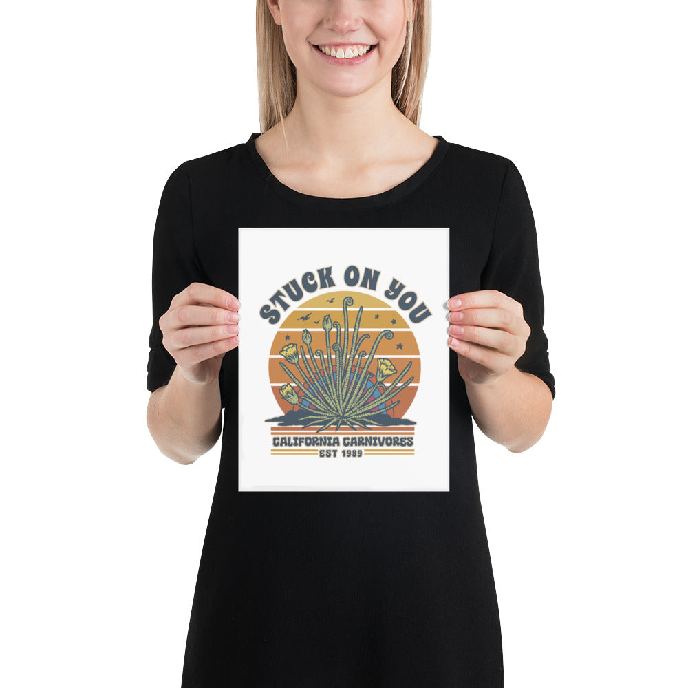 Person holding a poster with a desert plant design and text.