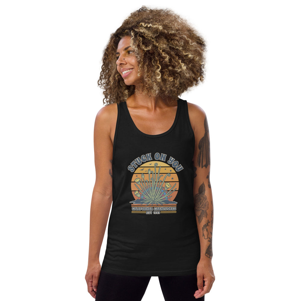 Woman wearing a black tank top with a graphic design on a white background