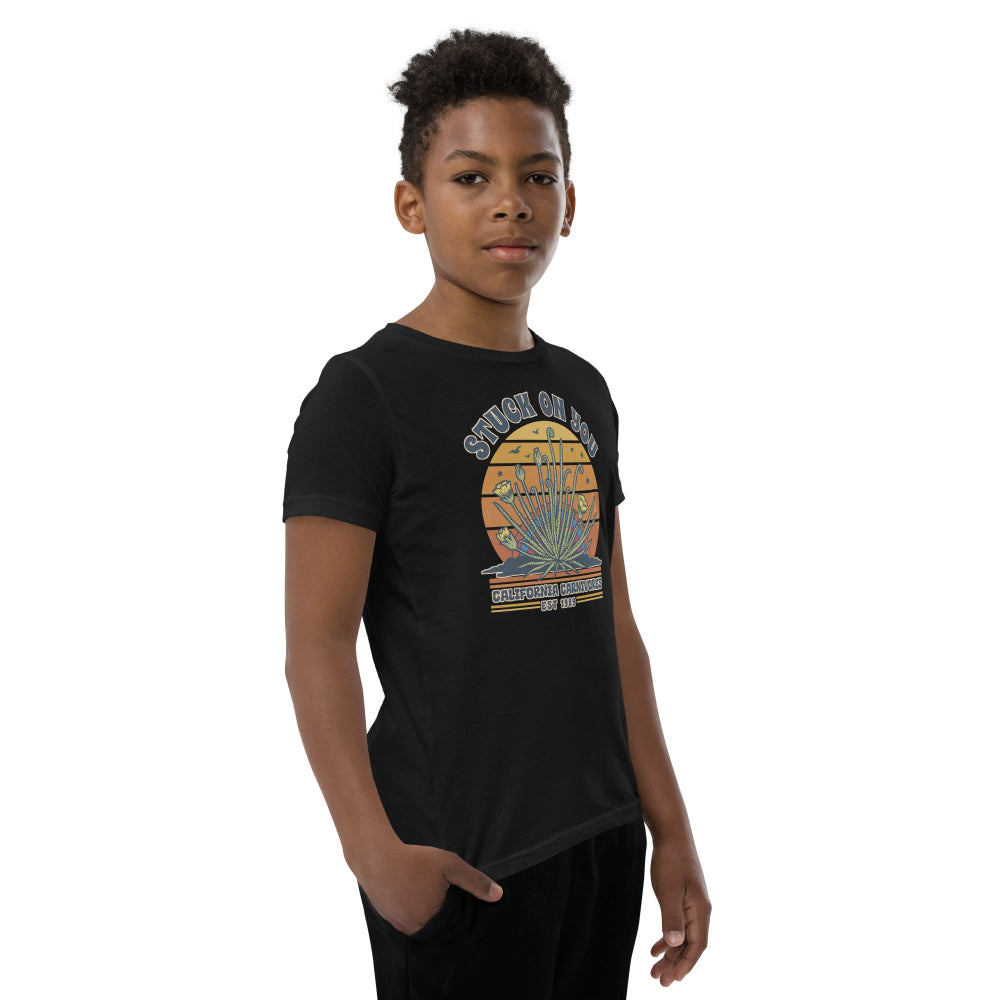 Child wearing a navy blue t-shirt with a graphic design on a white background
