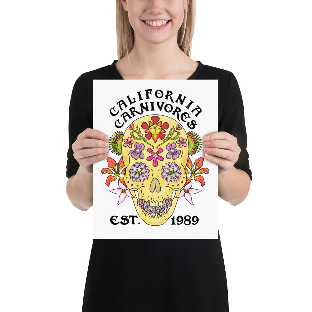 Person holding a poster with a colorful skull design and 'California Carnivores' text.