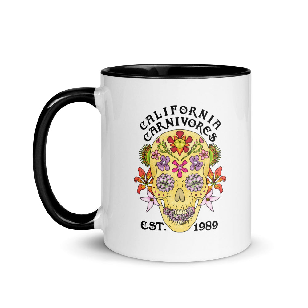 White mug with black handle featuring a colorful skull design and 'California Carnivores' text on a white background.
