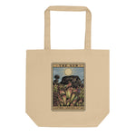 Tan tote bag with a tarot card-style design featuring plants and 'The Sun' card text.