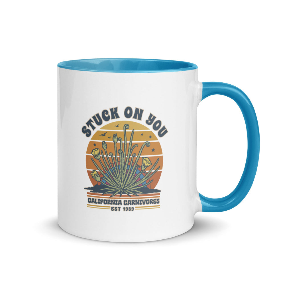 Mug with blue interior and handle featuring a graphic design and text on a white background