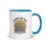 Mug with blue interior and handle featuring a graphic design and text on a white background