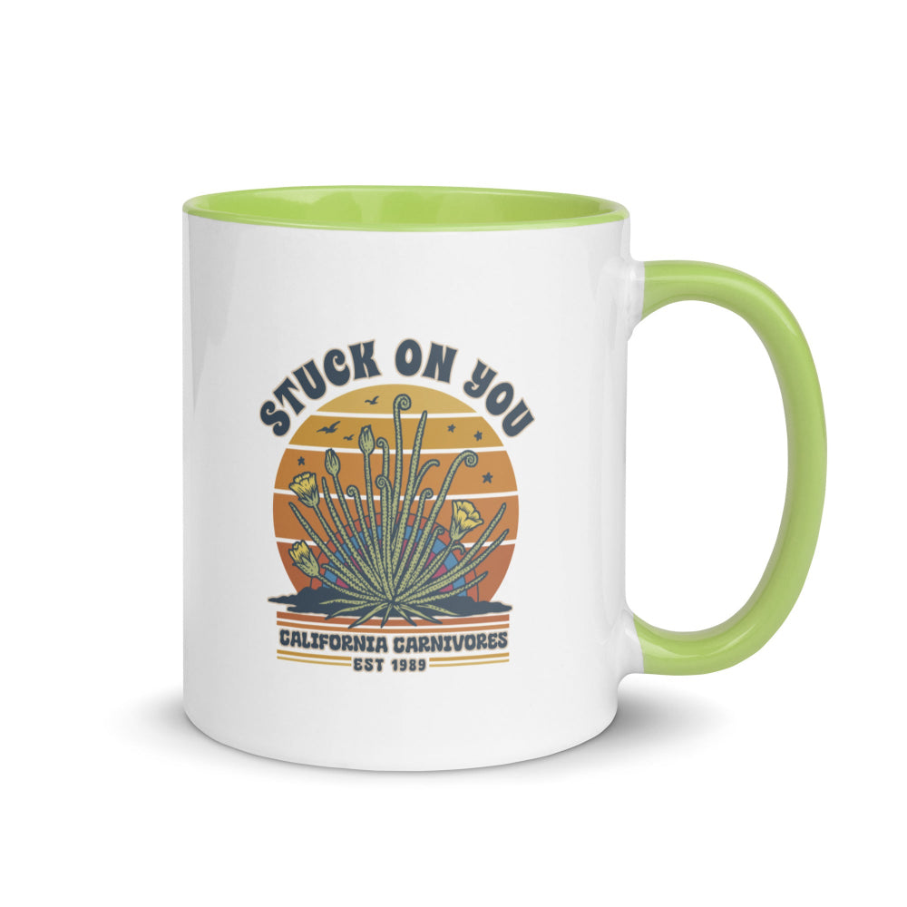 White mug with green interior and handle featuring a graphic design and text on a white background